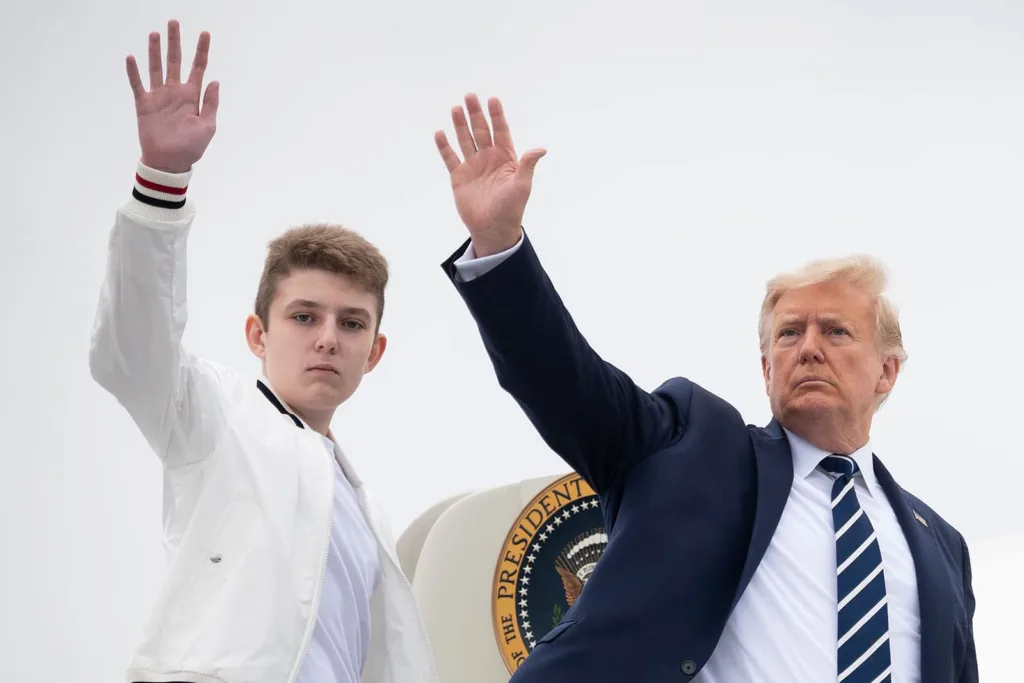 Donald Trump and Barron Trump wave while boarding Air Force One in 2020